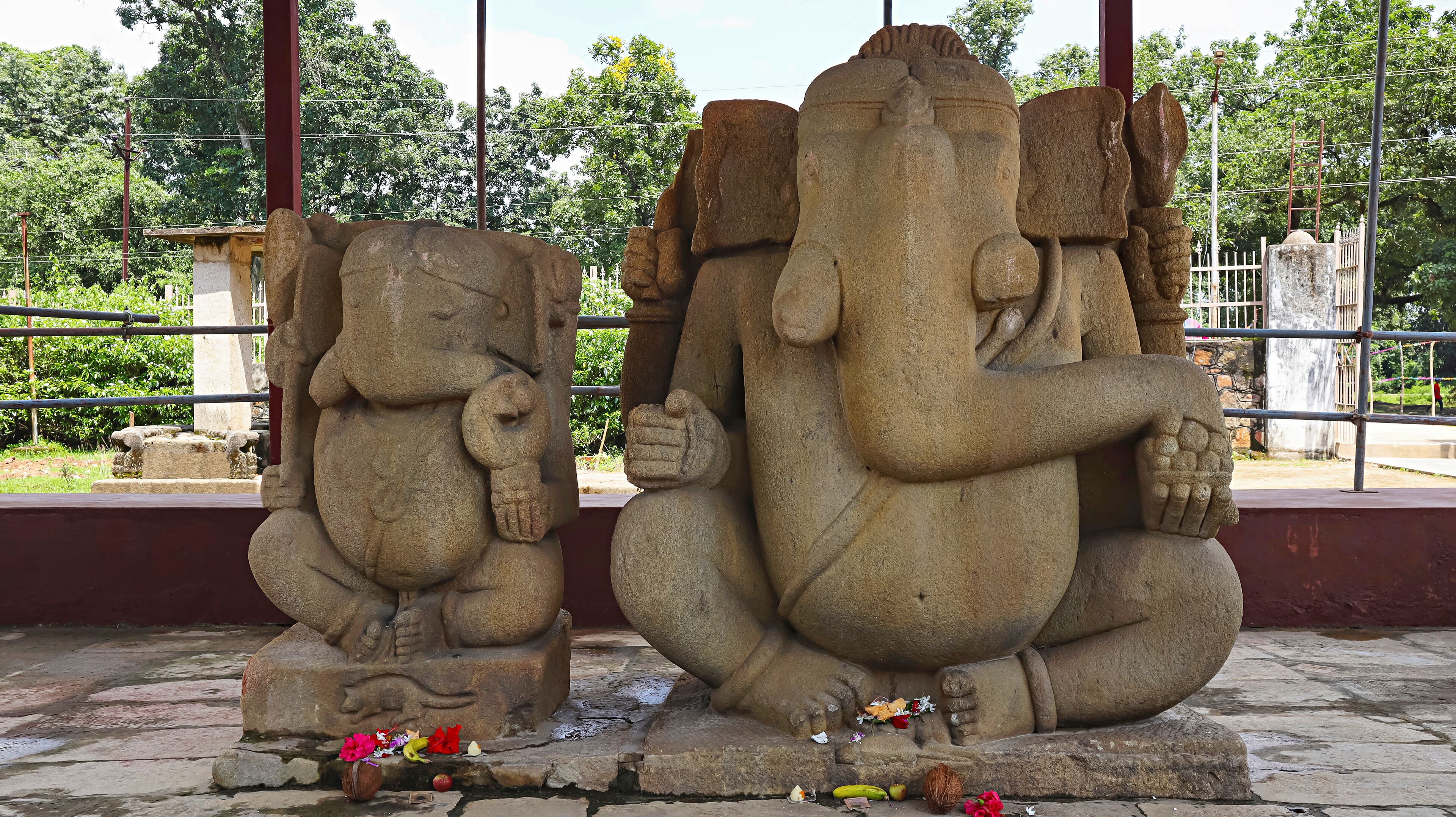 Two stone statues of elephants in a temple setting.