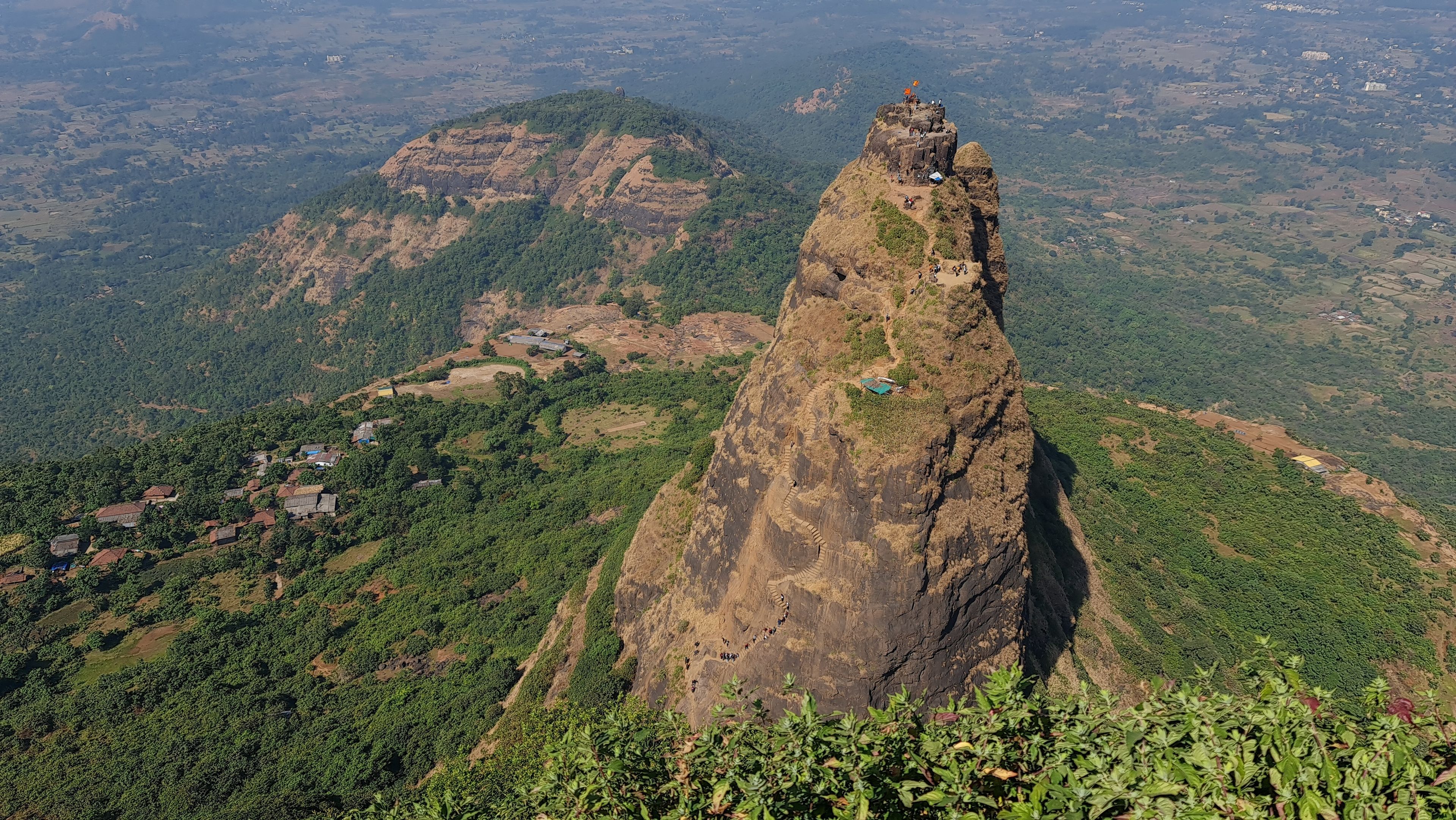 Kalavantin Durg pinnacle with trekkers climbing steep steps near Prabalgad Maharashtra India