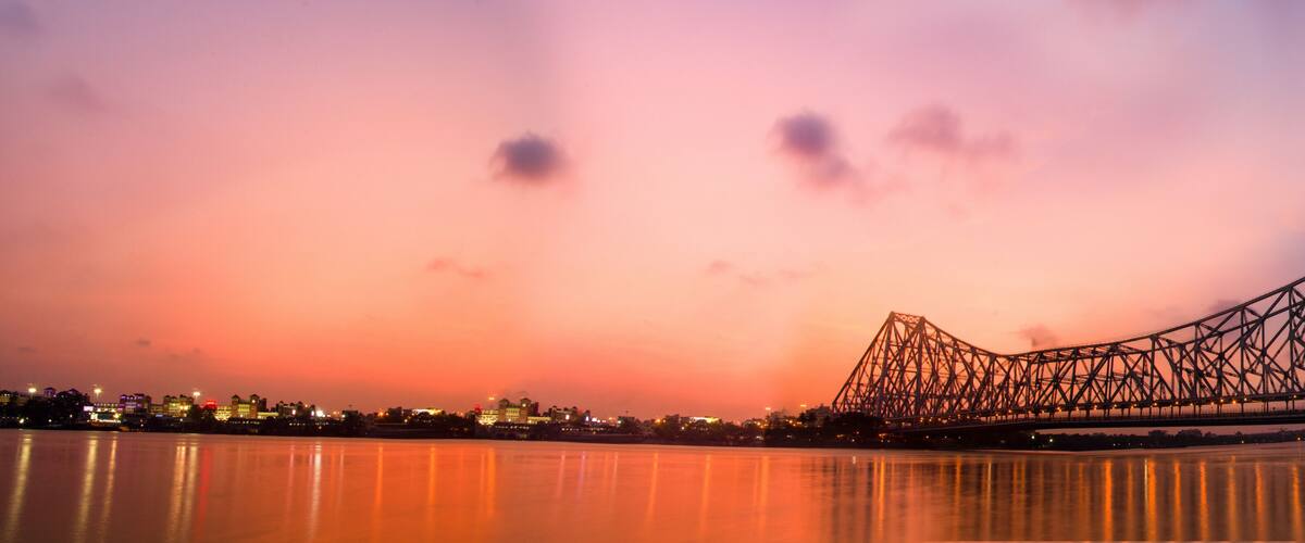 A bridge at sunset with reflections on water.