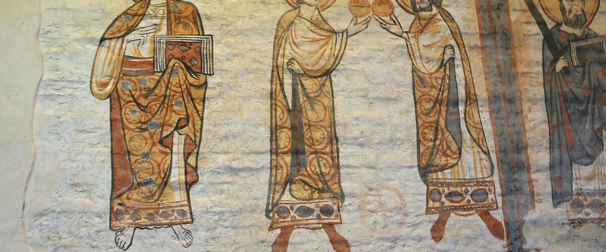 A fresco with three figures, each with halos and holding objects.