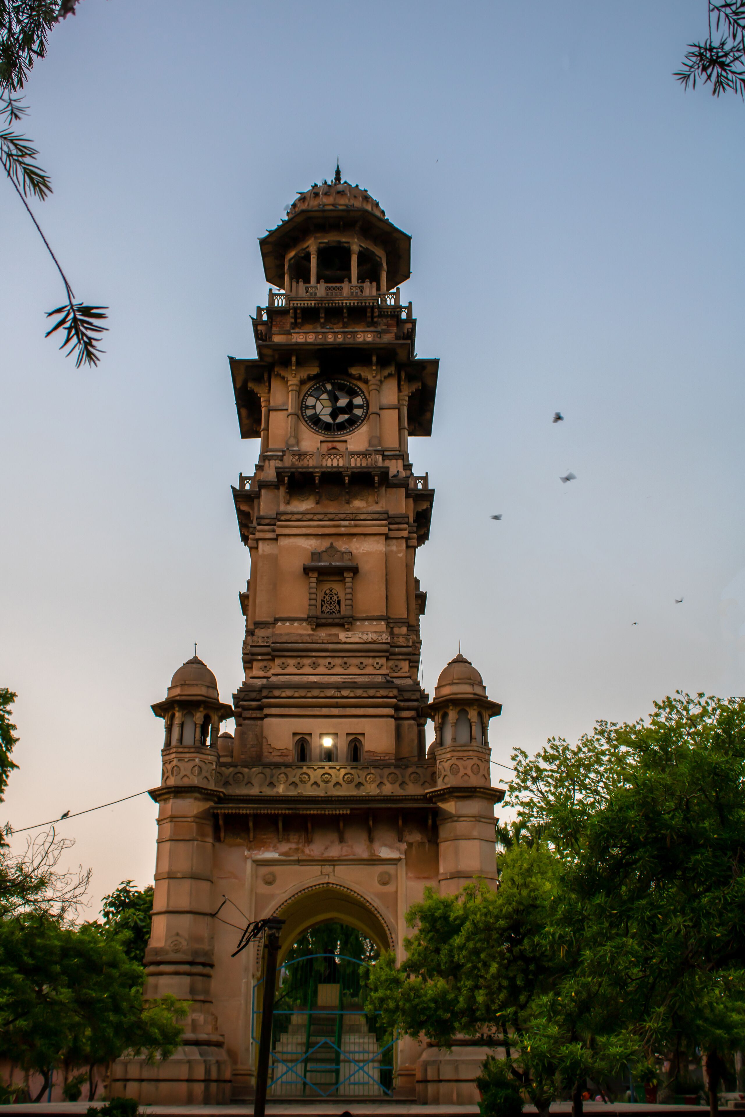 A historic clock tower with intricate architectural details and a dome on top.