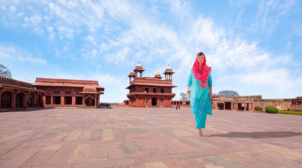An Indian woman dressed in traditional costume walks - Fatehpur Sikri - It is a city in Agra district in India (Constructed by Mughal emperor )