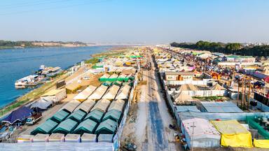 Aerial view of tent city and Triveni Sangam at The Maha Kumbh Mela in Prayagraj, Uttar Pradesh, India. The Mahakumbh Mela is a Hindu festival that happens every 12 years.