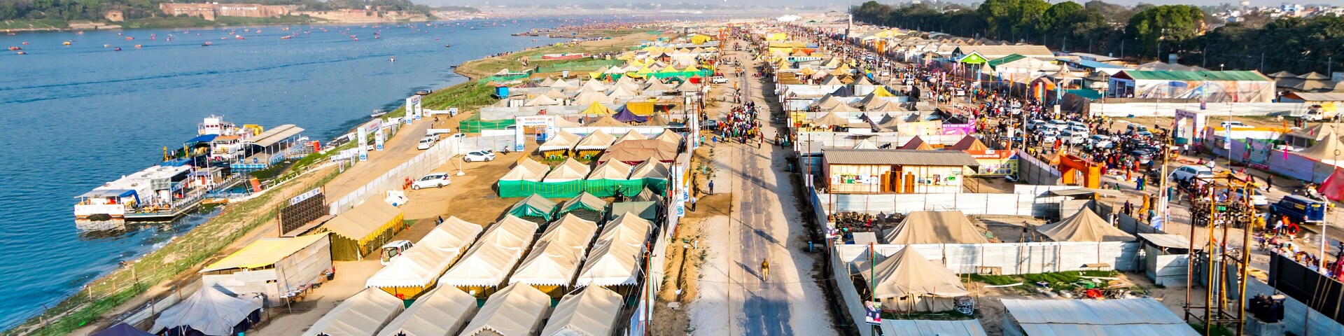 Aerial view of tent city and Triveni Sangam at The Maha Kumbh Mela in Prayagraj, Uttar Pradesh, India. The Mahakumbh Mela is a Hindu festival that happens every 12 years.