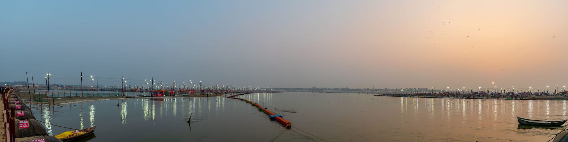 Kumbha Mela, Allahabad, Uttar Pradesh, India; 17-Feb-2019; lights on the river banks, sunset at Sangam, river Ganges