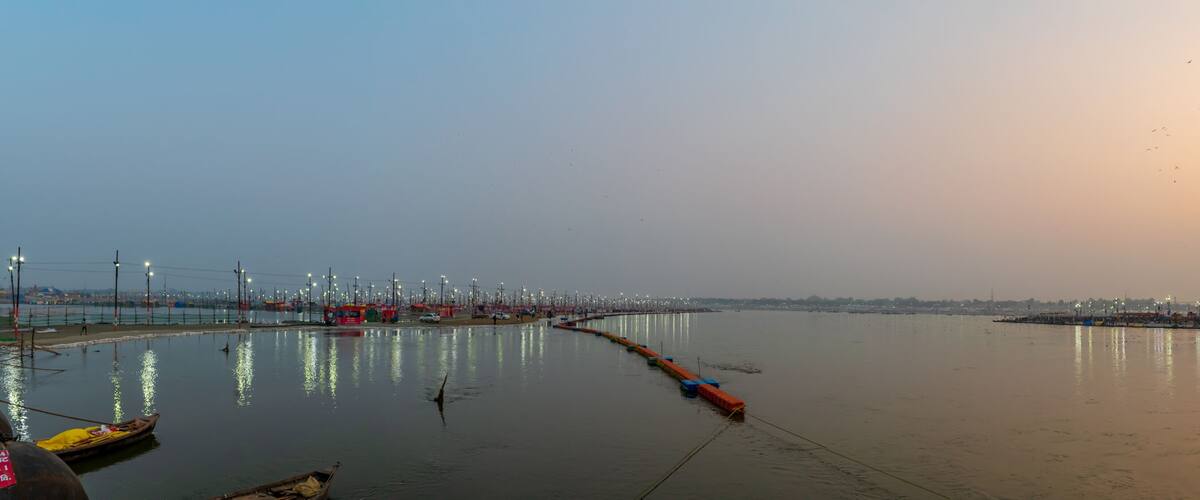 A river with boats, a bridge, and a cityscape in the background.