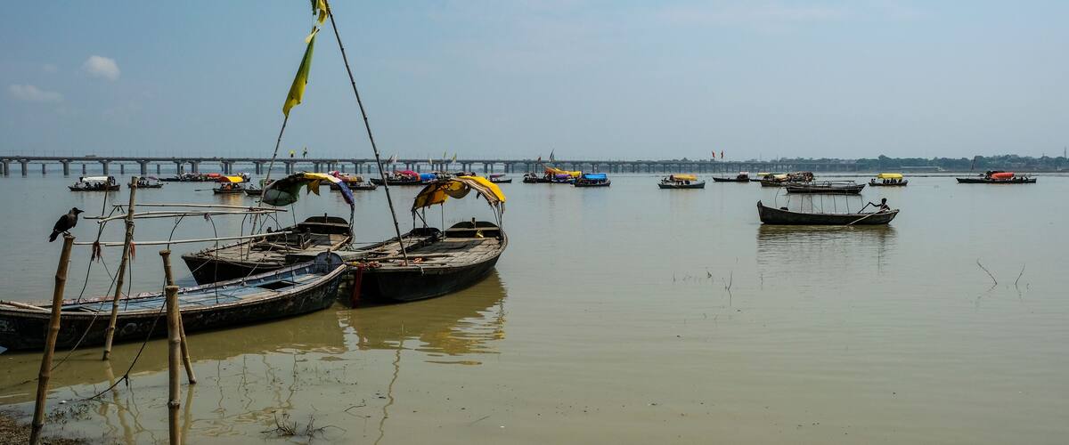 Allahabad, India - September 2020: Pilgrims in the Sangam going by boat to where the Ganges River and the Yamuna River meet on September 9, 2020 in Allahabad, Uttar Pradesh, India.