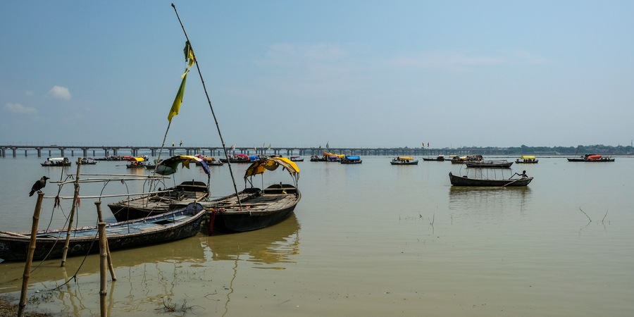 Allahabad, India - September 2020: Pilgrims in the Sangam going by boat to where the Ganges River and the Yamuna River meet on September 9, 2020 in Allahabad, Uttar Pradesh, India.