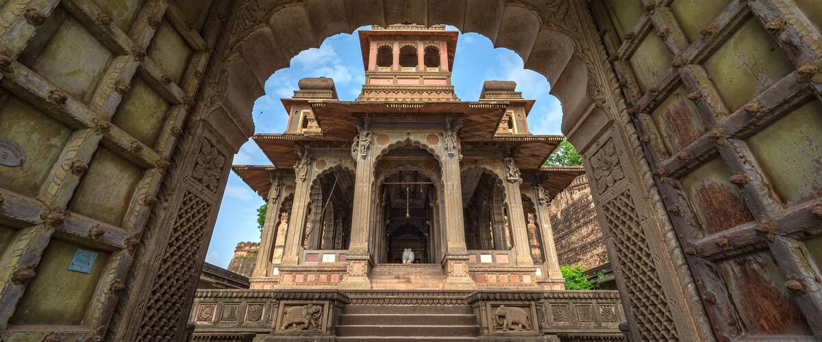 An ornate temple entrance with detailed carvings and a central archway.