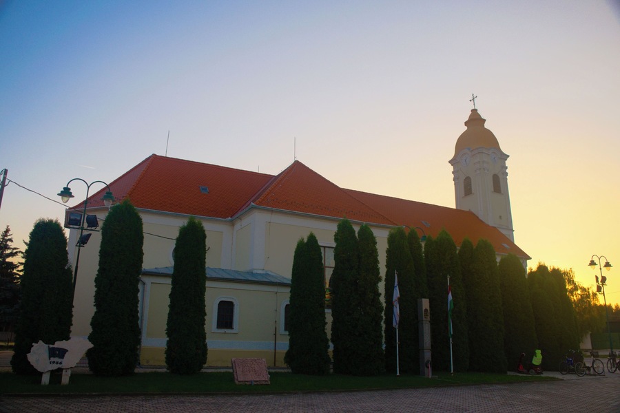 A church with a red roof and a bell tower.