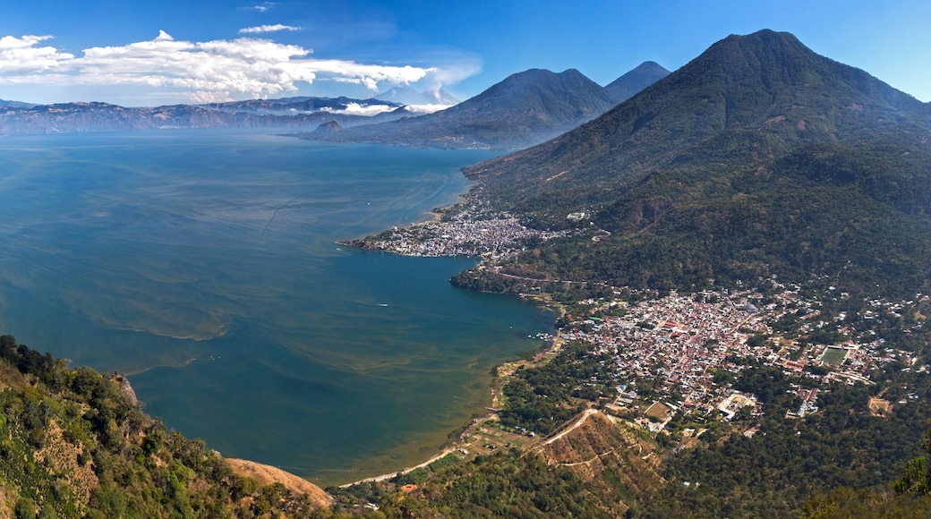 Wide Panoramic Aerial Landscape View of Blue Lake Atitlan and Guatemala Volcanoes from Indian Nose Mountain with distant Panajachel,San Pedro,San Juan and San Marcos Fisherman Villages on Horizon