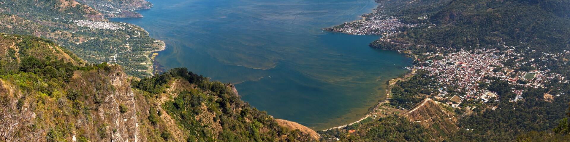 A coastal city with mountains and a large body of water.