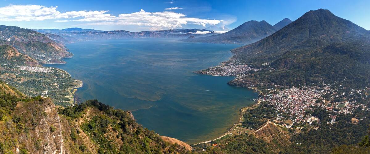 A coastal city with mountains and a large body of water.