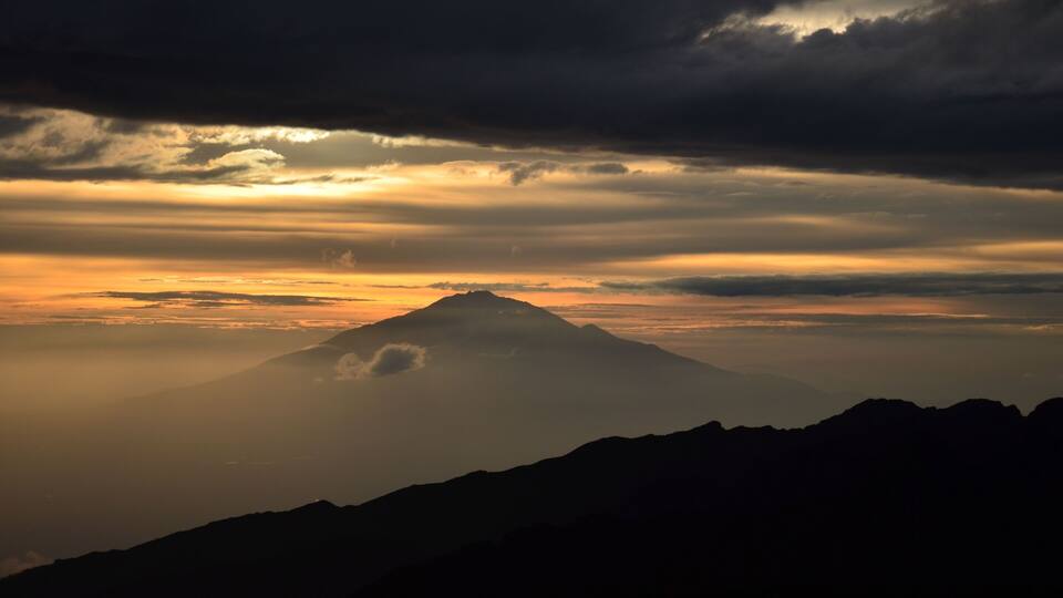 beautiful sunset on the kilimanjaro with a view of mount meru in tanzania shira camp.Hike to the highest mountain afirka