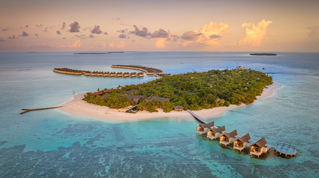Aerial view of Kuredhivaru Island with beautiful beach and luxurious resort surrounded by turquoise ocean, Noonu Atoll, Maldives.