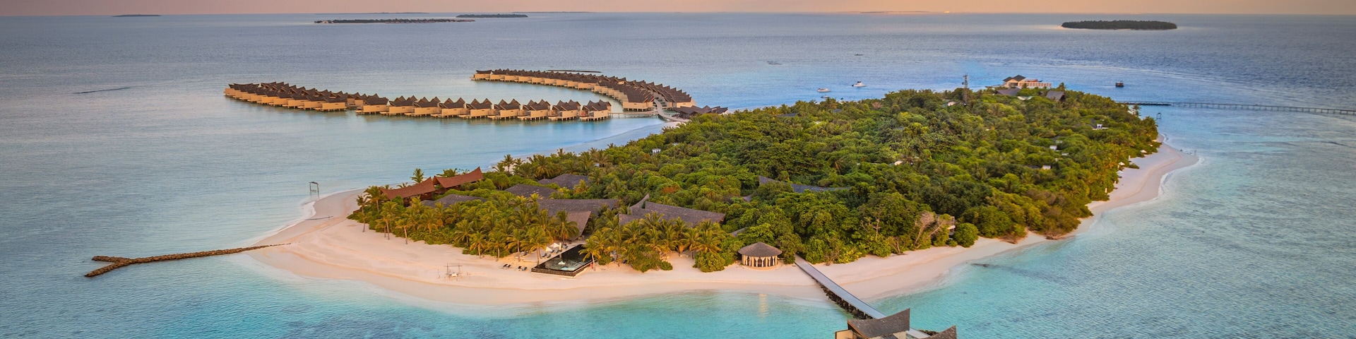 Aerial view of Kuredhivaru Island with beautiful beach and luxurious resort surrounded by turquoise ocean, Noonu Atoll, Maldives.