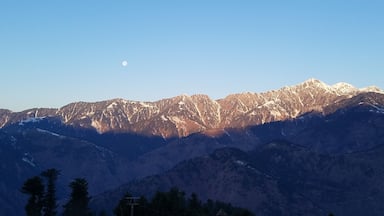 Moon, Sunlight, Snow and Mountains, view from Cedarwood Resort, KPK, Pakistan.