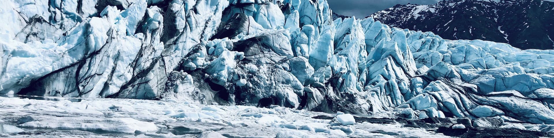 A glacier with ice formations and a river.