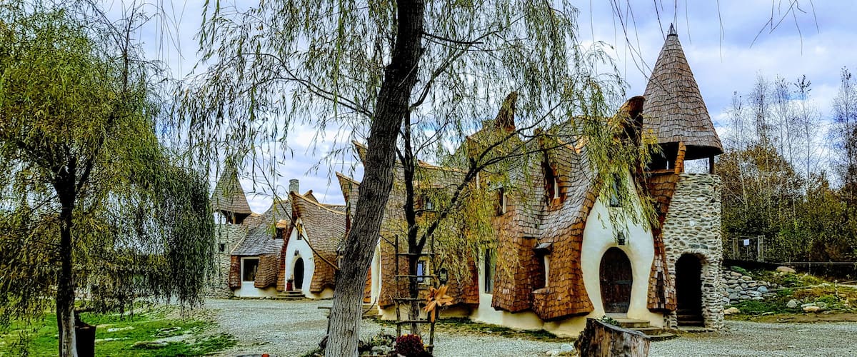 A village with traditional stone houses and a prominent tower.