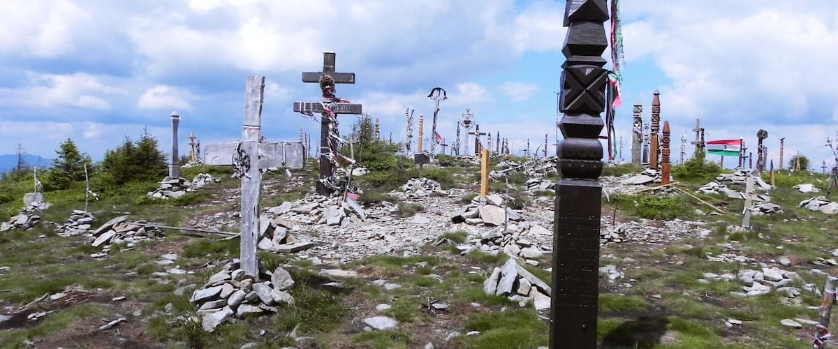 A cemetery with numerous crosses and a prominent totem pole.