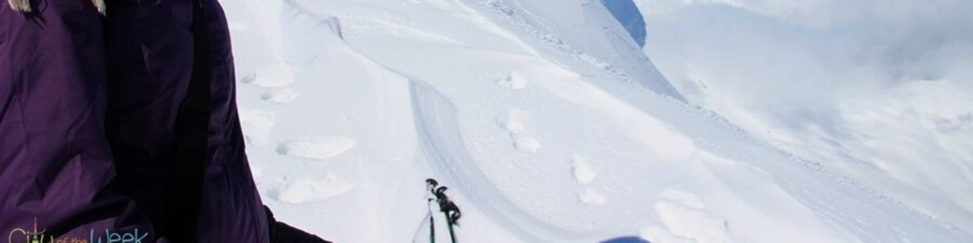 A person skiing on a snowy mountain slope.