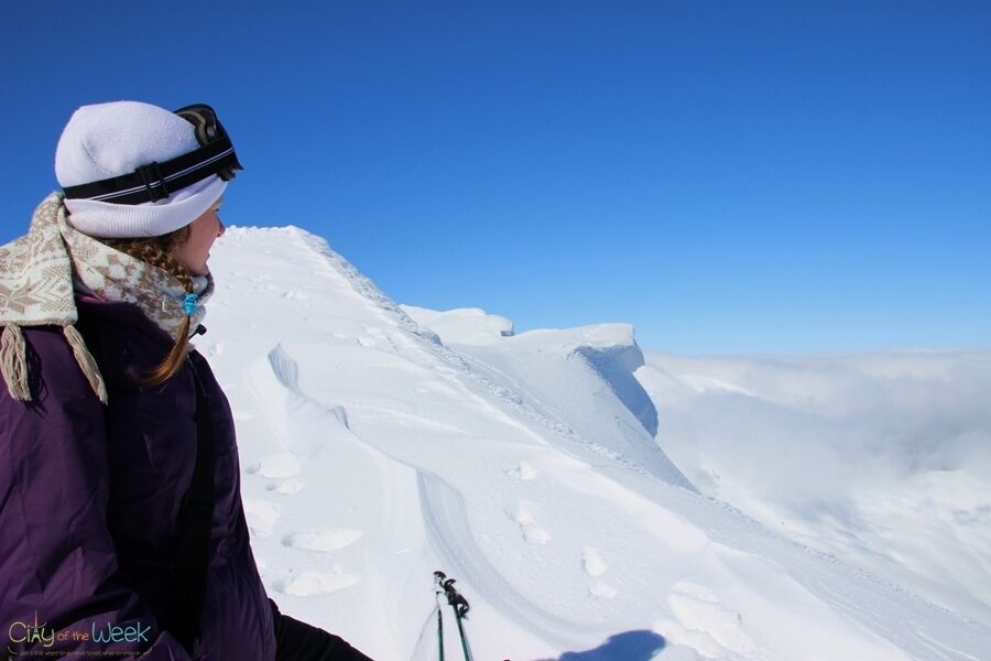 A person skiing on a snowy mountain slope.