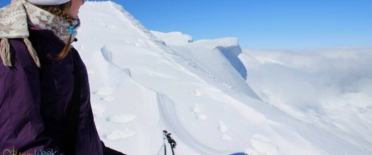 A person skiing on a snowy mountain slope.