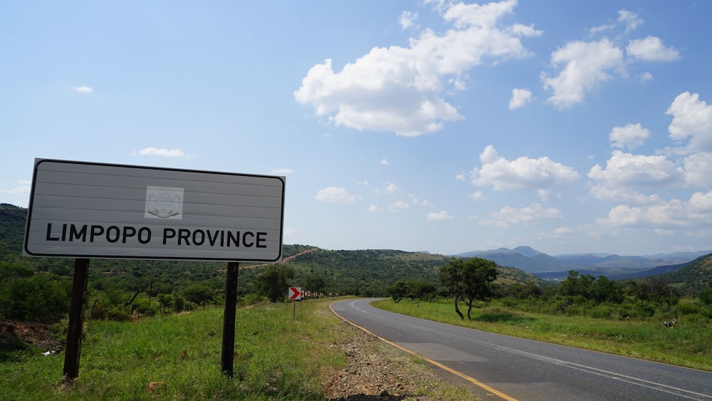 A road sign for Limpopo Province with a scenic landscape in the background.