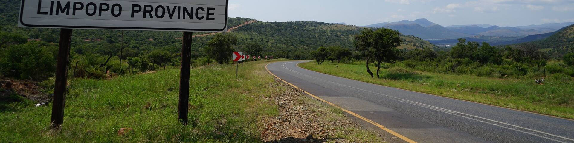 A road sign for Limpopo Province with a scenic landscape in the background.