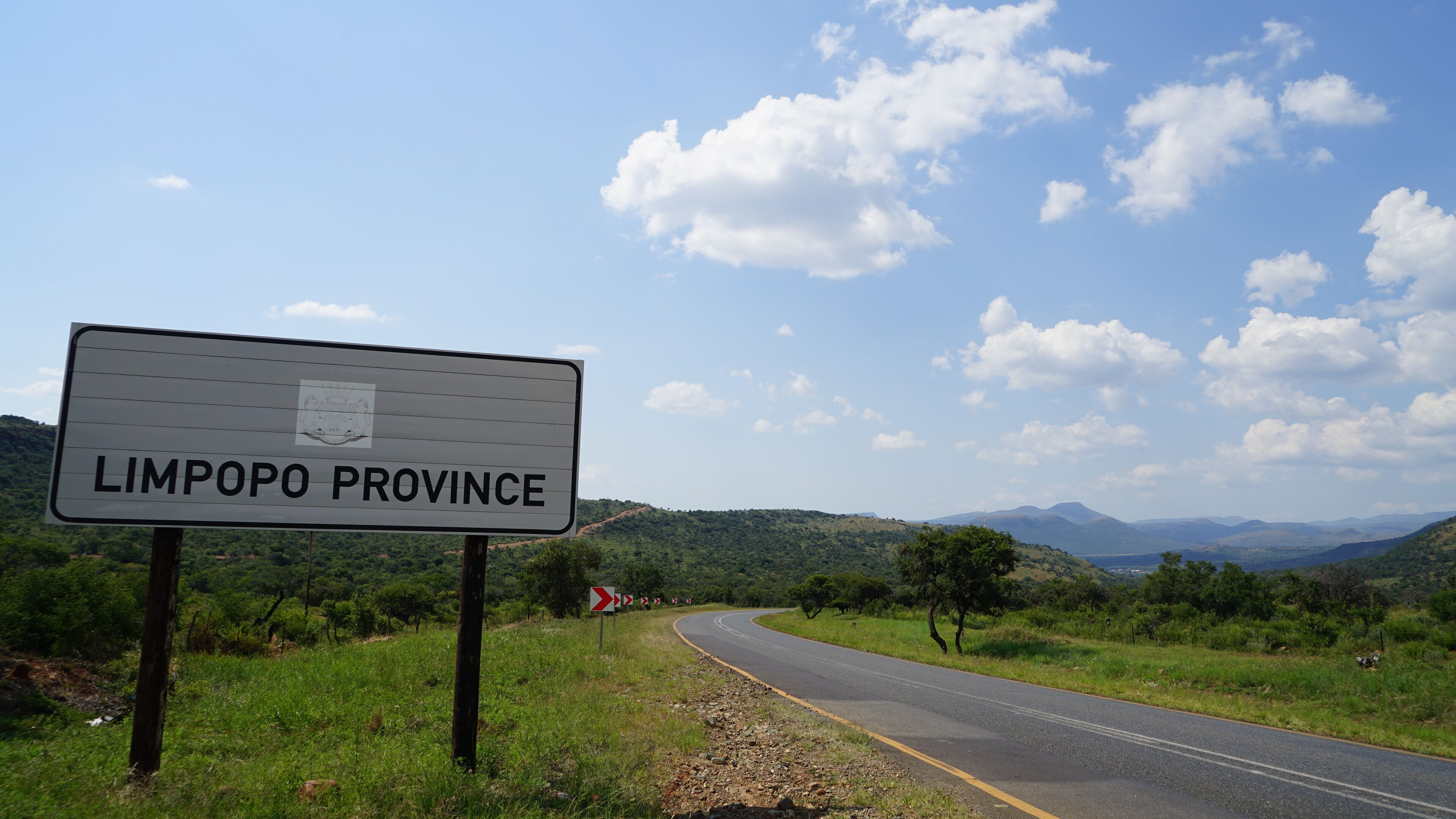 A road sign for Limpopo Province with a scenic landscape in the background.