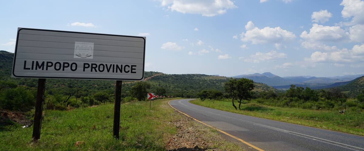 A road sign for Limpopo Province with a scenic landscape in the background.