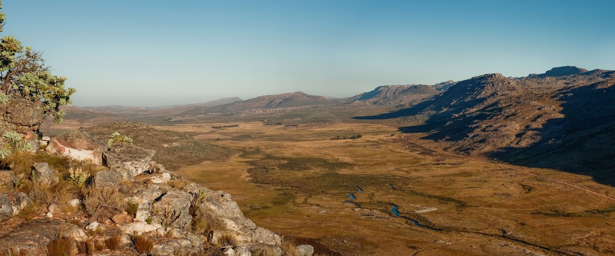 A mountainous landscape with rocky outcrops and sparse vegetation.