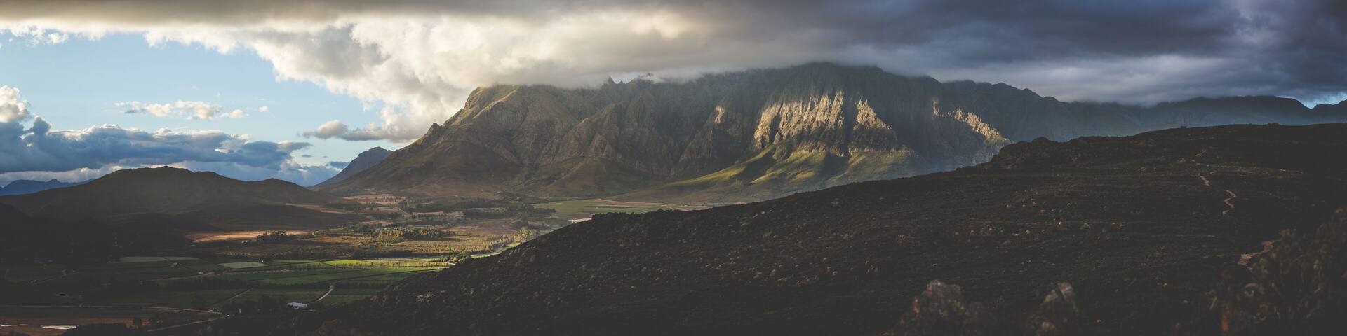 A mountainous landscape with a valley and a river.