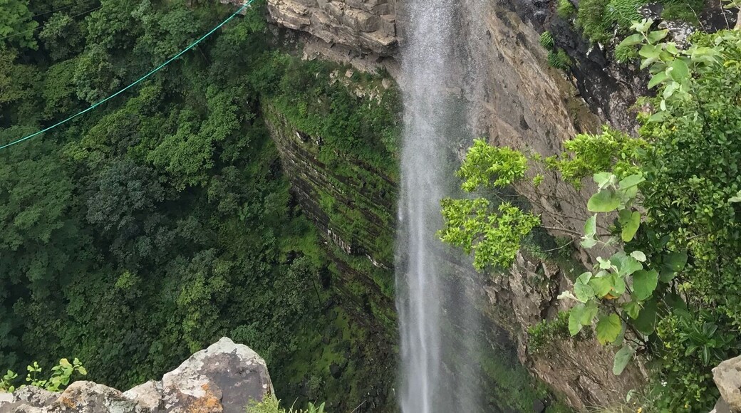 A torrent of water from a river pours in to the Oribi Gorge while adventurists wait to get harnessed for a gravity defining dive into the abyss. #river