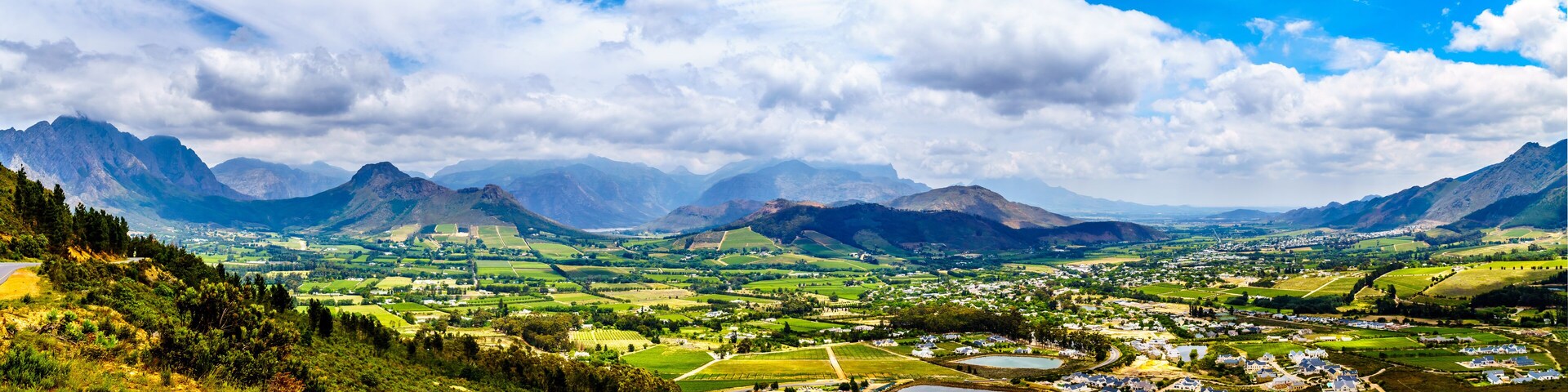 Panorama view of the Franschhoek Valley in the Western Cape of South Africa with its many vineyards in the Cape Winelands, surrounded by the Drakenstein mountain range, as seen from Franschhoek Pass