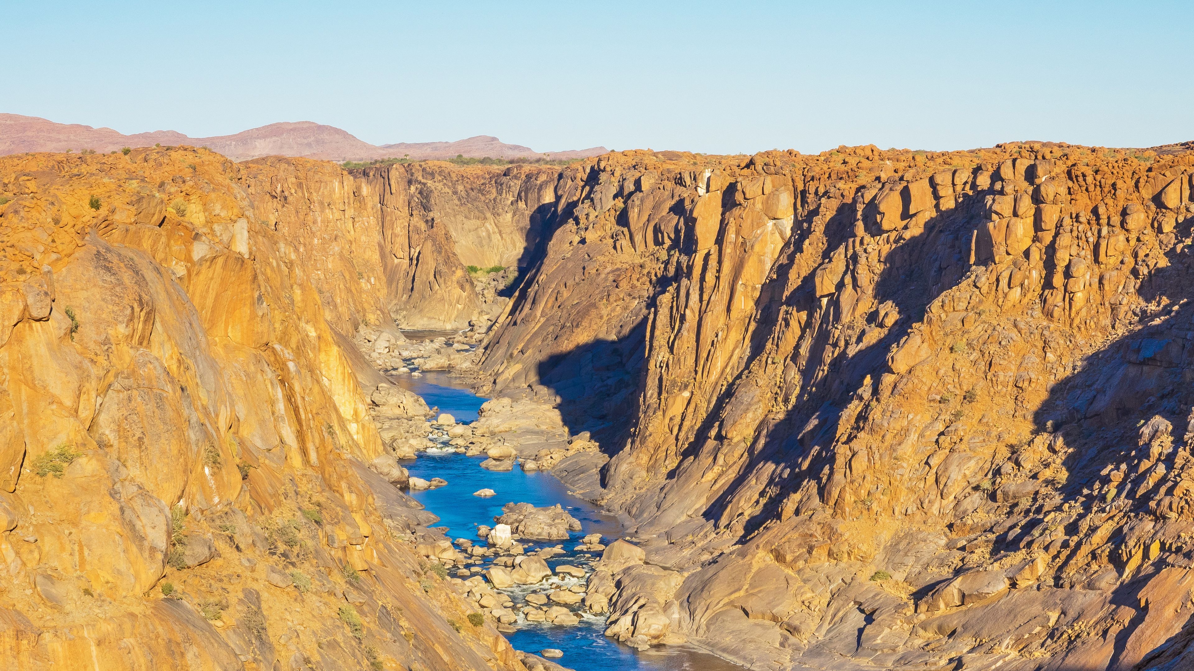 A canyon with a river flowing through it.