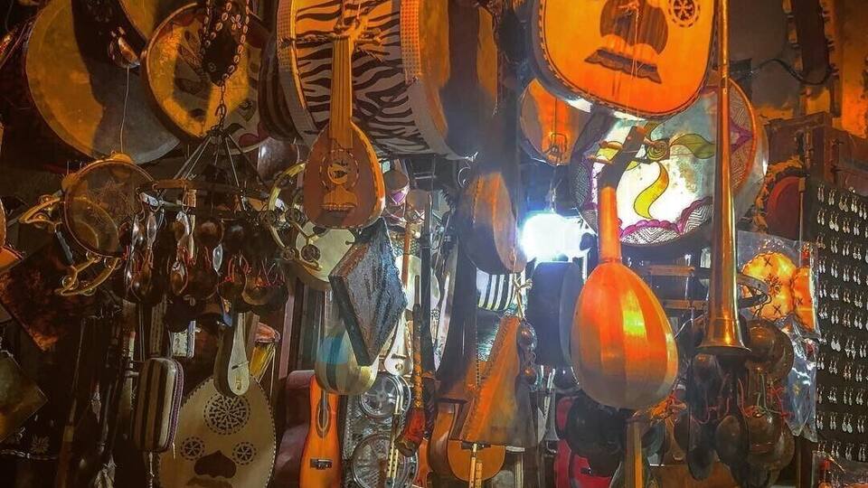 A variety of traditional stringed instruments hanging in a shop.