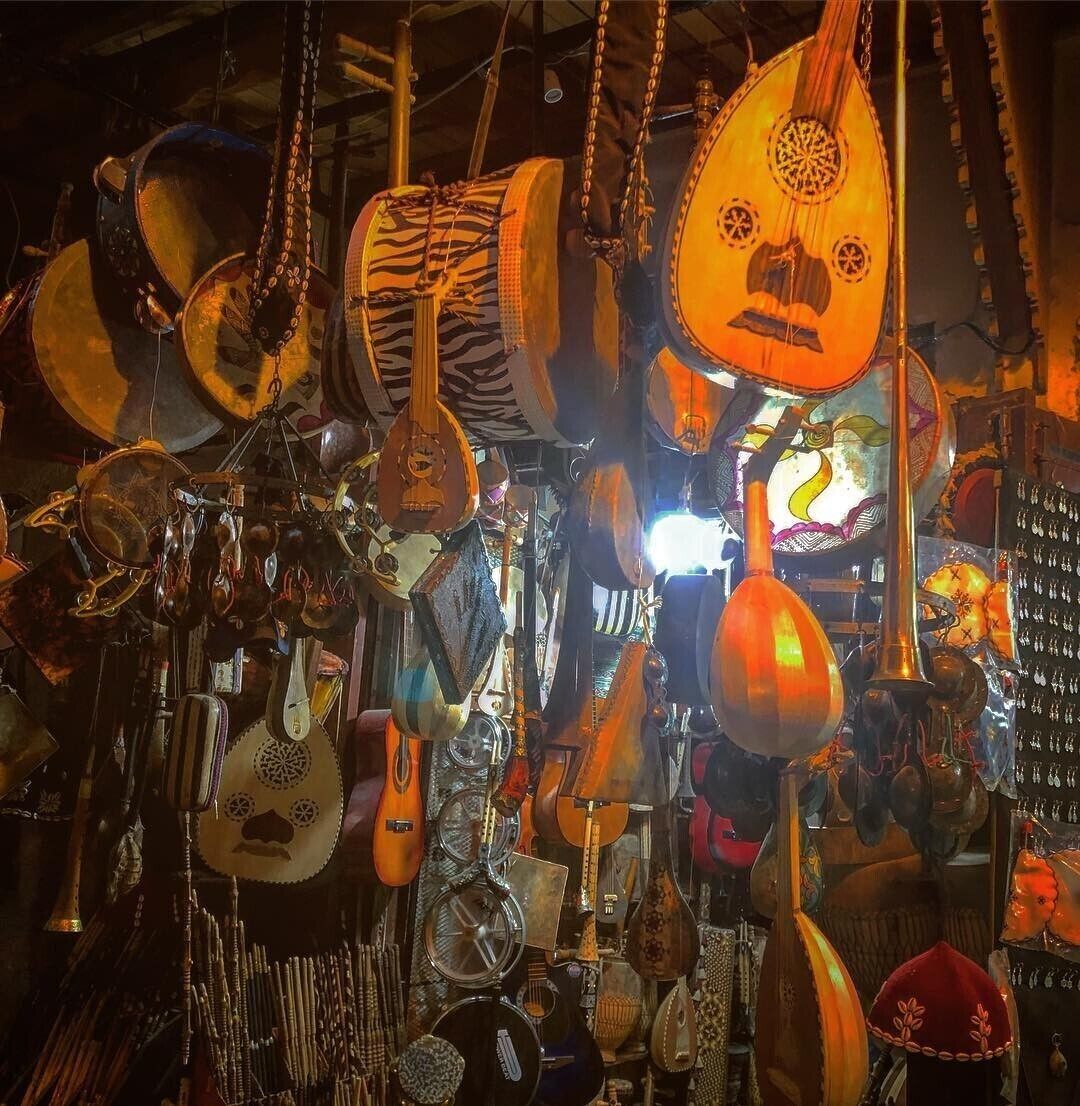 A variety of traditional stringed instruments hanging in a shop.