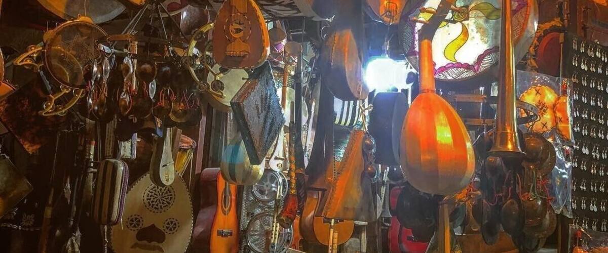 A variety of traditional stringed instruments hanging in a shop.