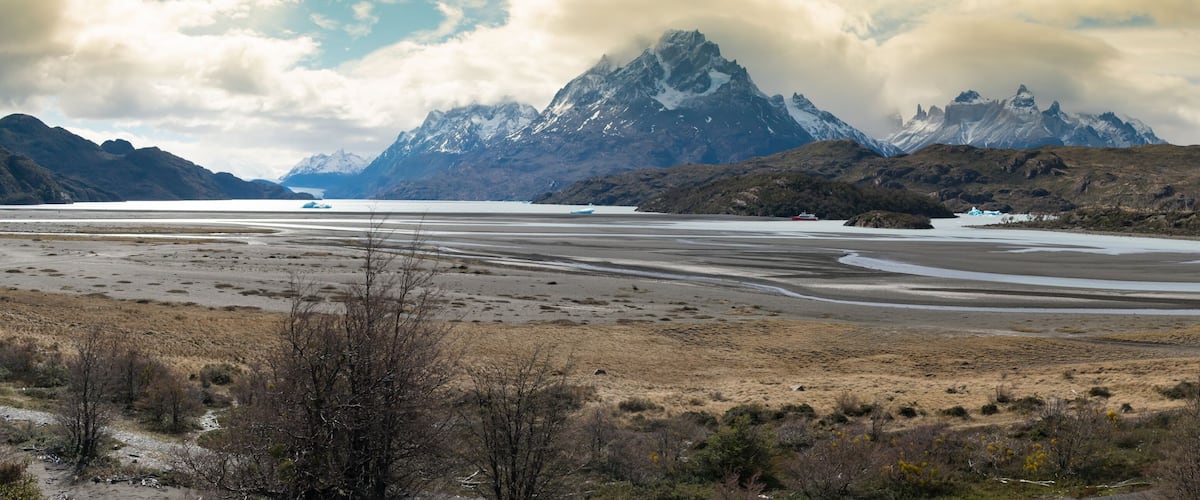 A glacier with mountains in the background.