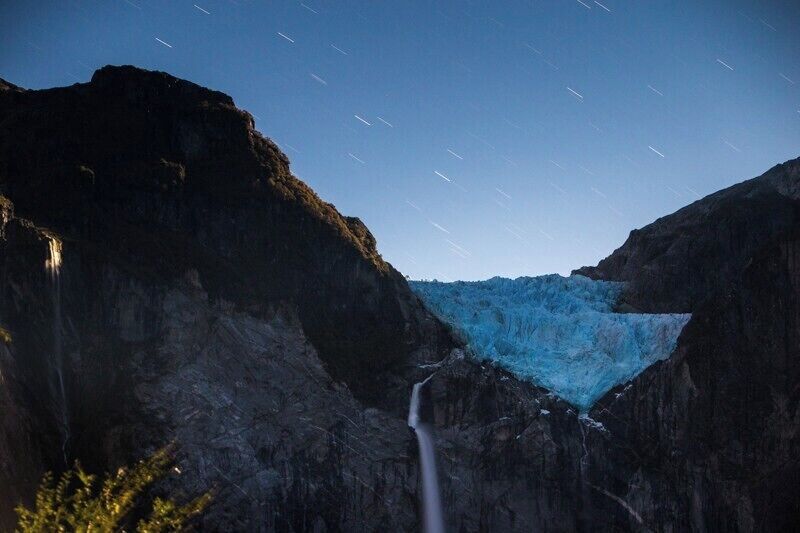 Dear lord this place!  I had never heard of it before doing my bit of research on Patagonia, and it ended up being my favourite spot on the Carretera Austral. 
I shot this at night just as a full moon was rising to give a bit of light to the glacier and waterfall. 