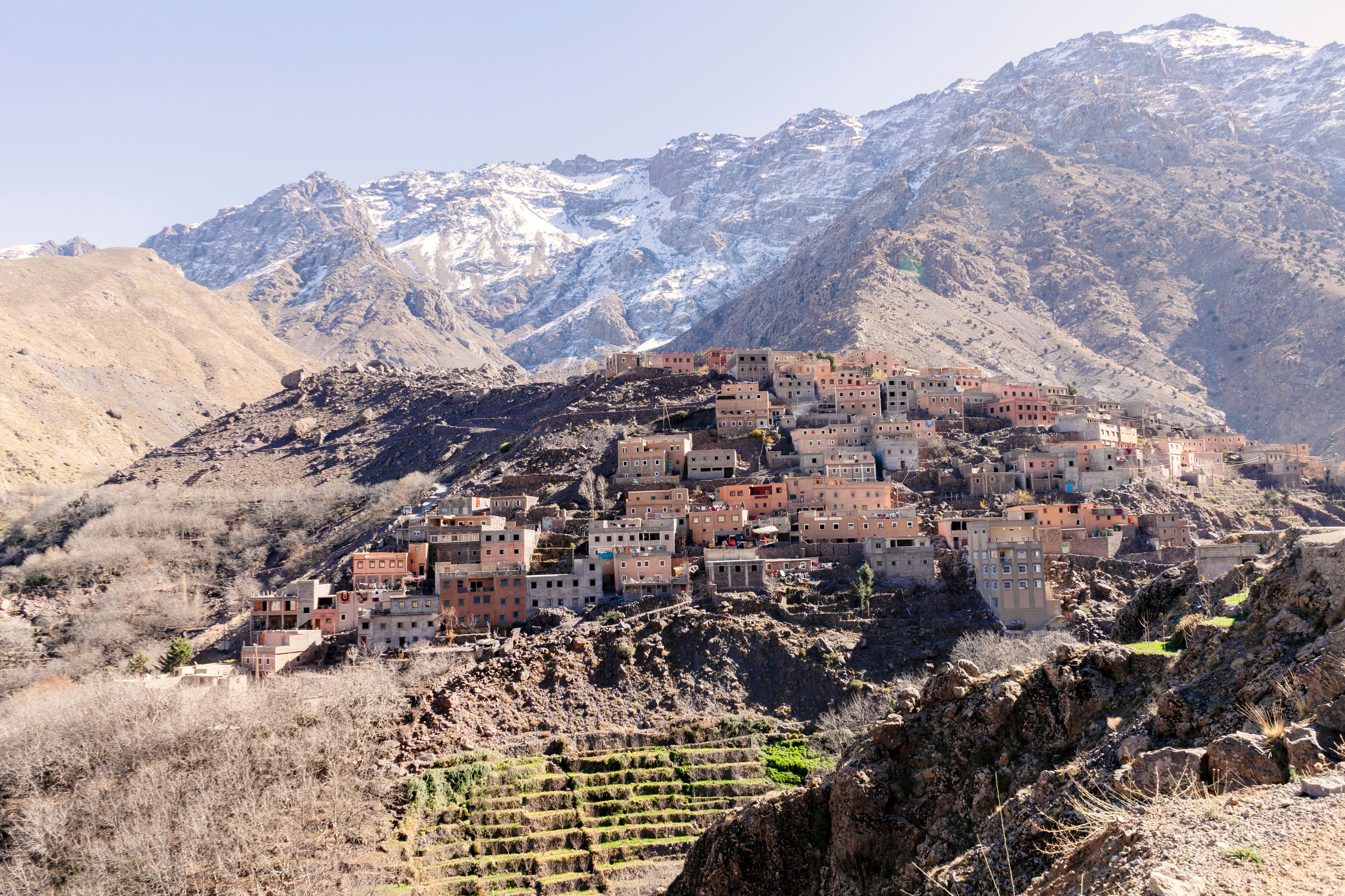 A mountainous village with terraced fields and buildings.