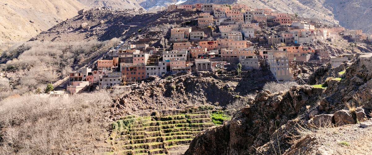 A mountainous village with terraced fields and buildings.
