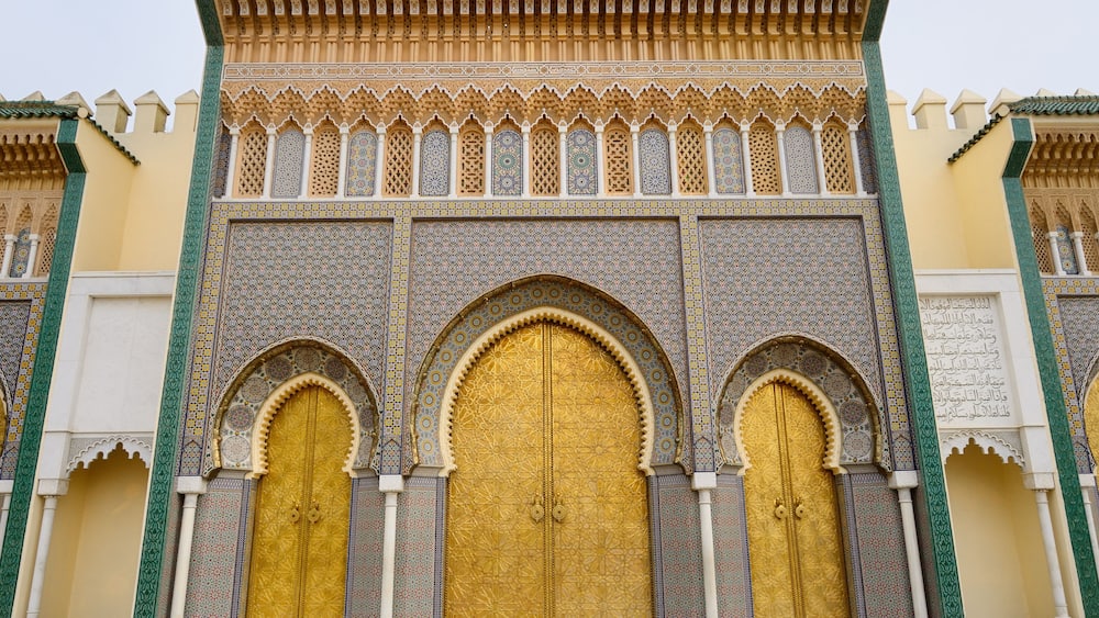 Brass doors to the Dar El Makhzen the Kings Royal Palace with intricate Zellige tilework in Fes Morocco