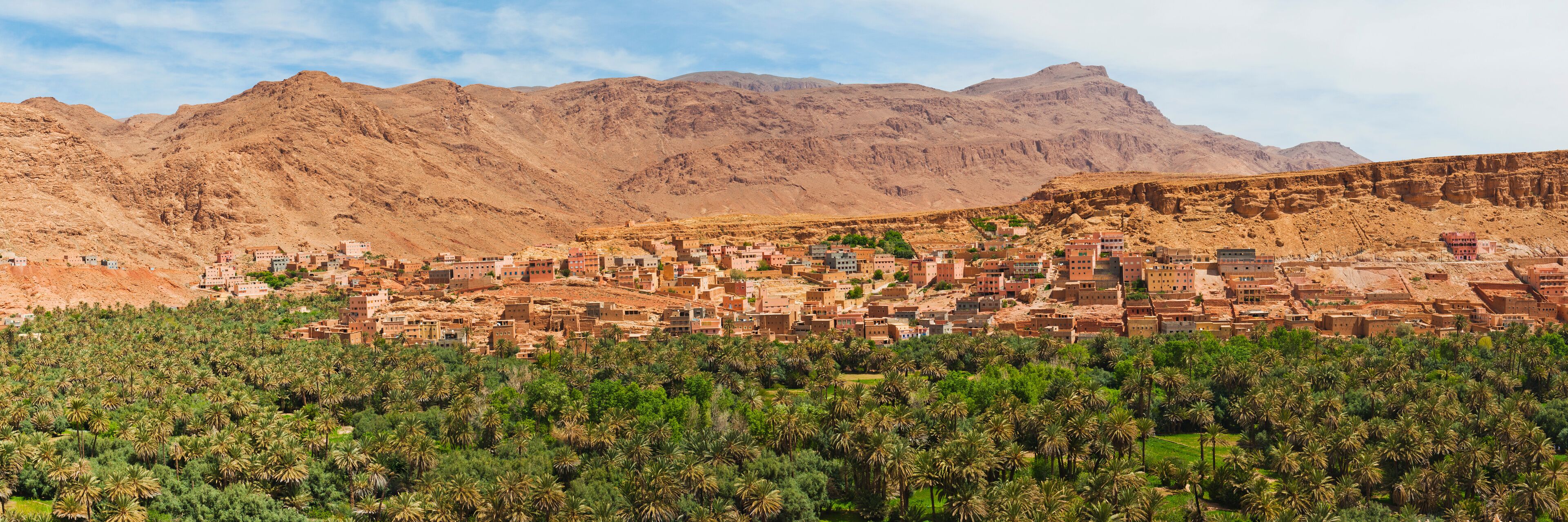A mountainous landscape with a village nestled among the hills.