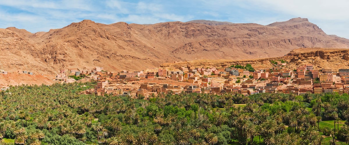 A mountainous landscape with a village nestled among the hills.