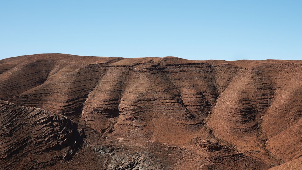 Layered hills with a clear sky.