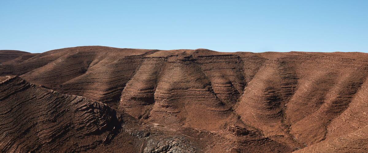 Layered hills with a clear sky.