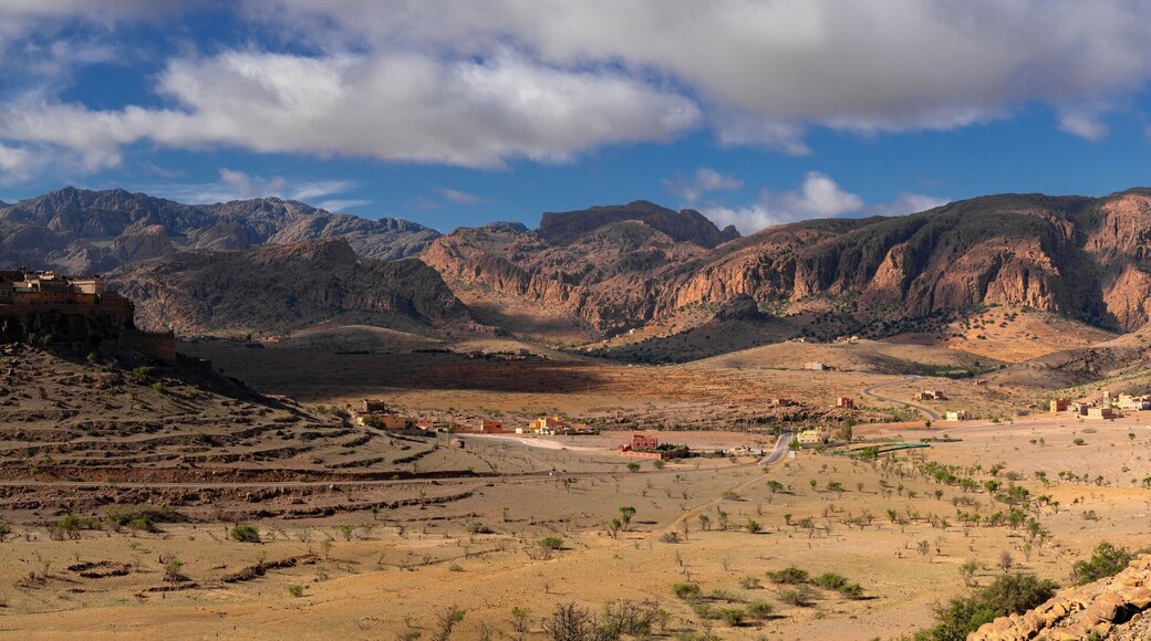 panorama landscape view of the Altas mountains in Morocco with the Kasbah Tizourgane on the hilltop in the centre