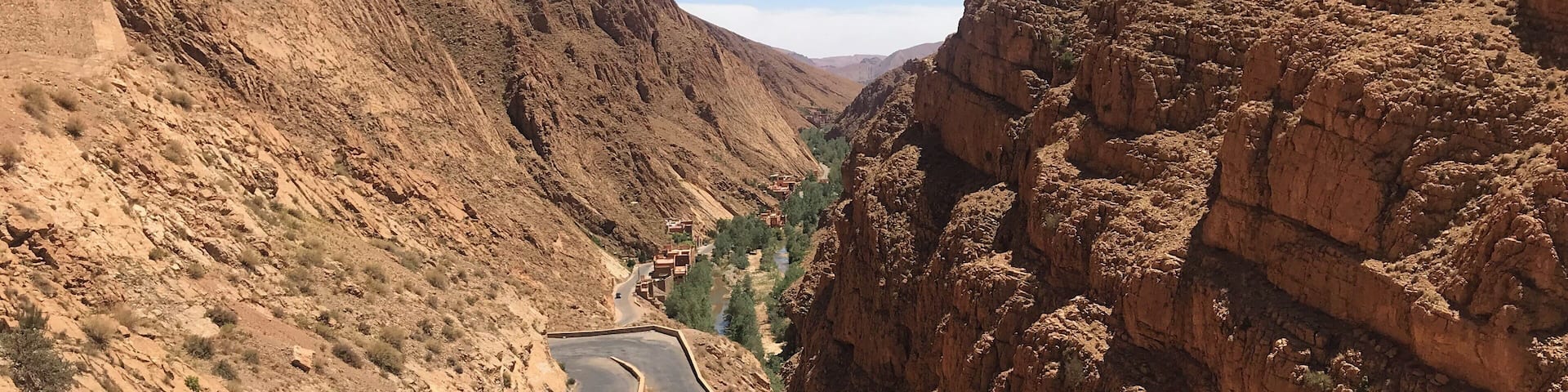 Road leading down into Dades Gorge where an oasis of plants, a Berber village and water live between beautiful sandstone mountains. #dadesgorge #morocco #africa #berber #earthbound #travel #slowtravel #travelmorocco #mountains #sandstonemountains #moroccanmountains #roadtrip #ilovemorocco #flashpackingbarbie